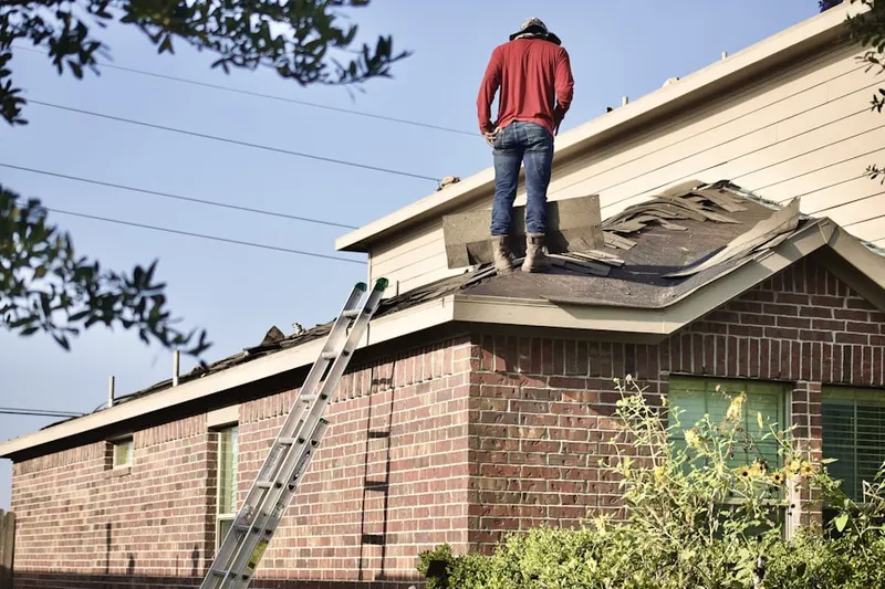 Professional roofer working on a residential roof in Happy Valley